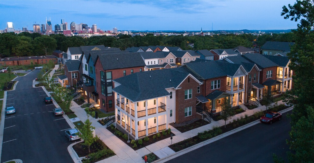 Modern townhome development with the Nashville skyline in the background